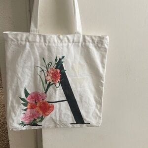 A letter tote bag with flower design